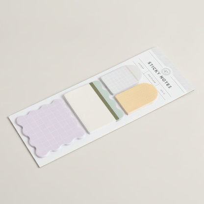 Set of sticky notes in various colors with a clear plastic cover on a white background