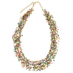 Multicolor sequin beaded necklace with gold metal rings and twisted metal on a white background