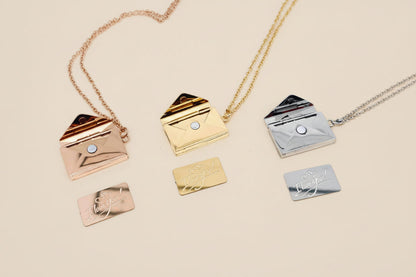 Set of gold and silver envelope-shaped pendants on a white background