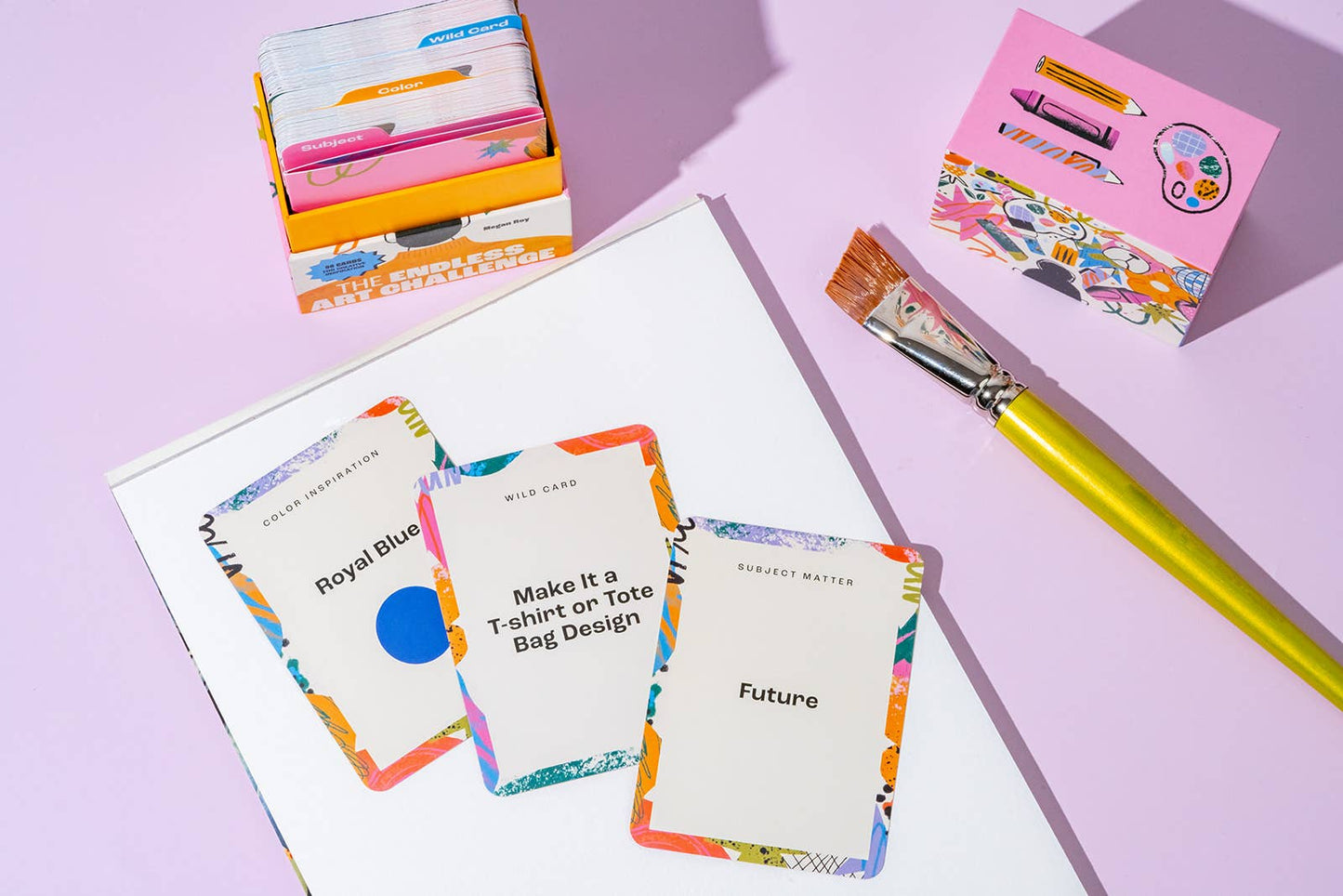 Color swatch cards with a paintbrush on a light purple background