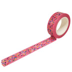 Roll of bright pink washi tape with multi-color sprinkles on a white background