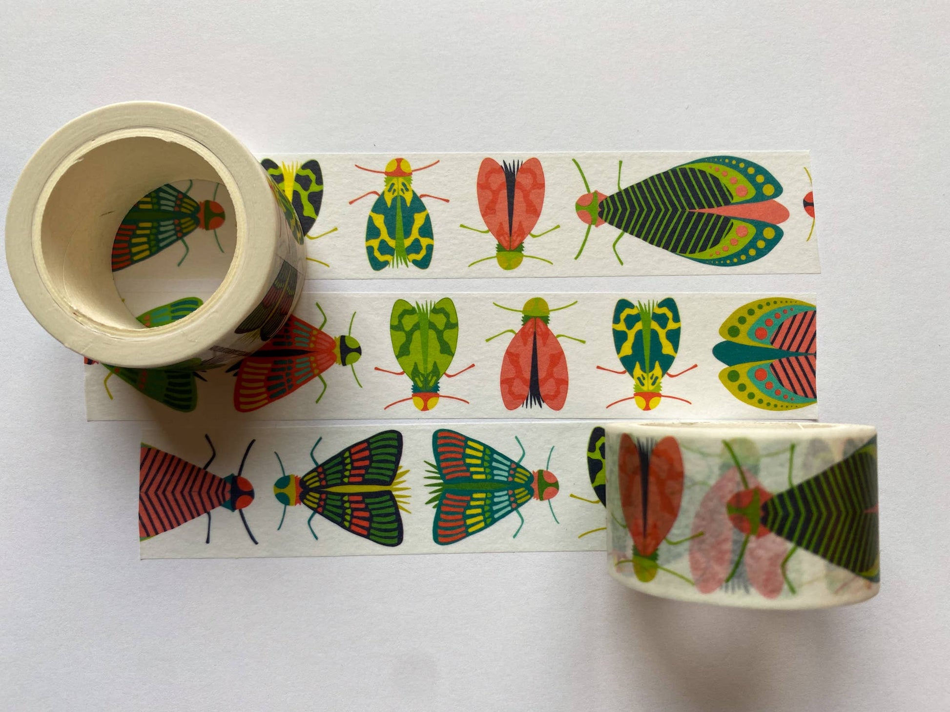 Roll of Mondo Bug Washi Tape featuring large colorful bugs on unspooled strip