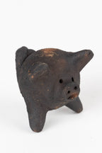 Small black pig-shaped ceramic figure on a white background