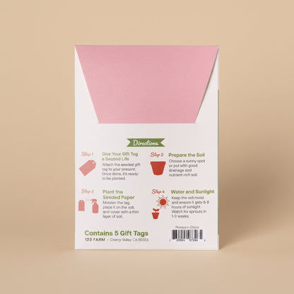 Seeded paper gift tag packaging with pink and white design on a white background