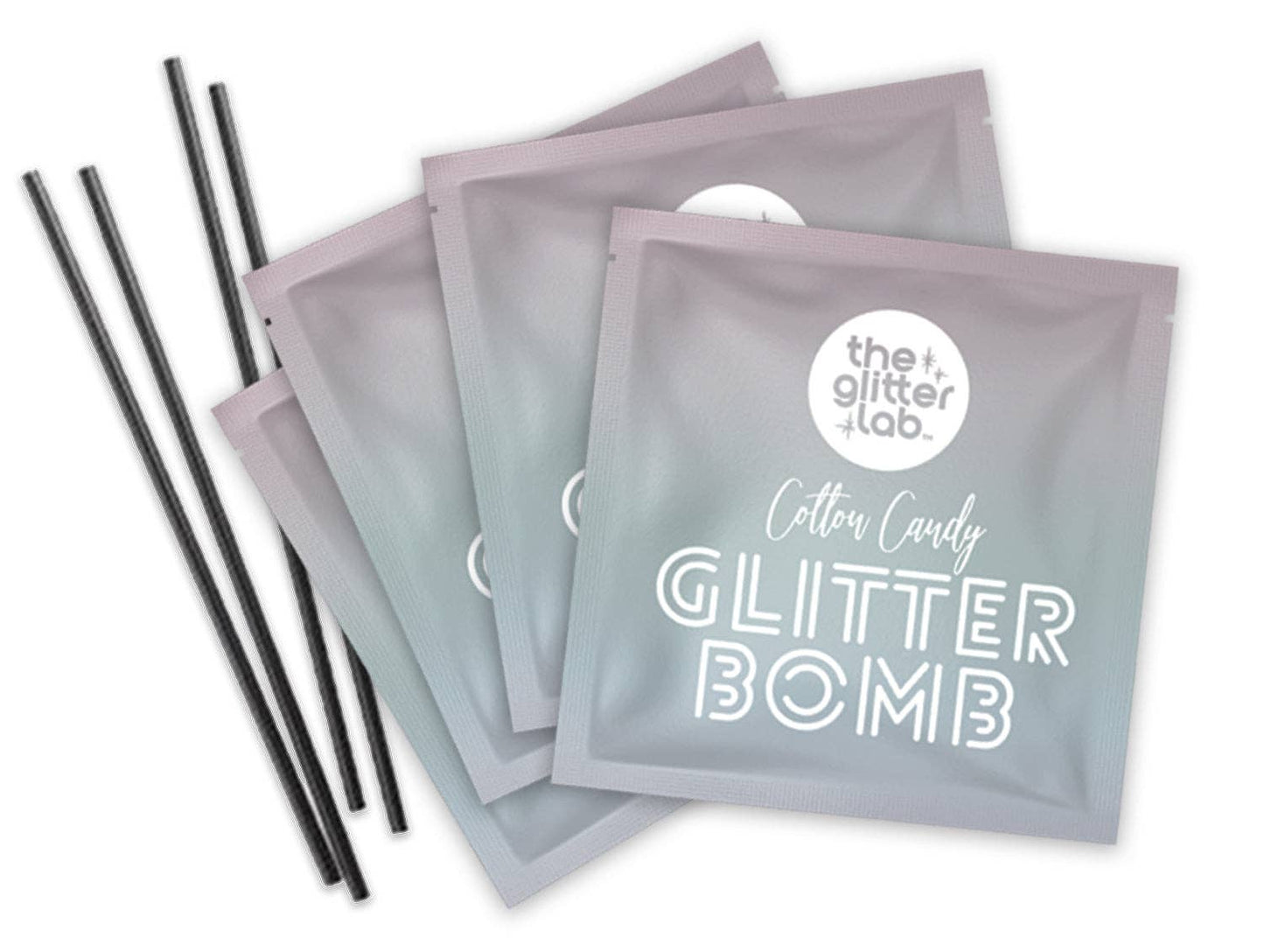 Close up of Green Glitter Bomb packets with stir sticks included in every box.