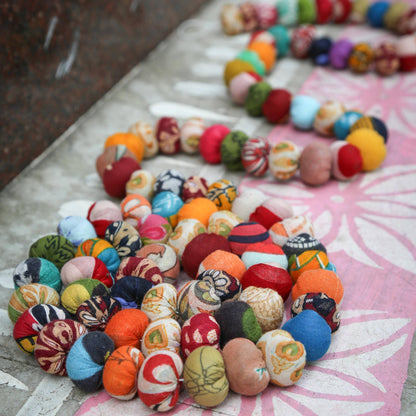 Sari bead garland coiled as a decorative accent on a festive table setup