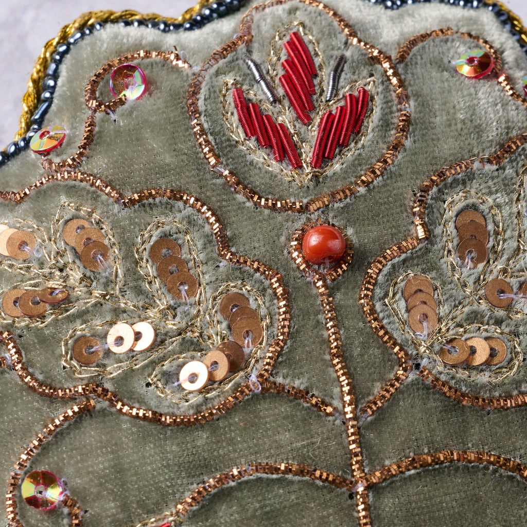 Close up view of the handcrafted sewing and beaded details on the ornament