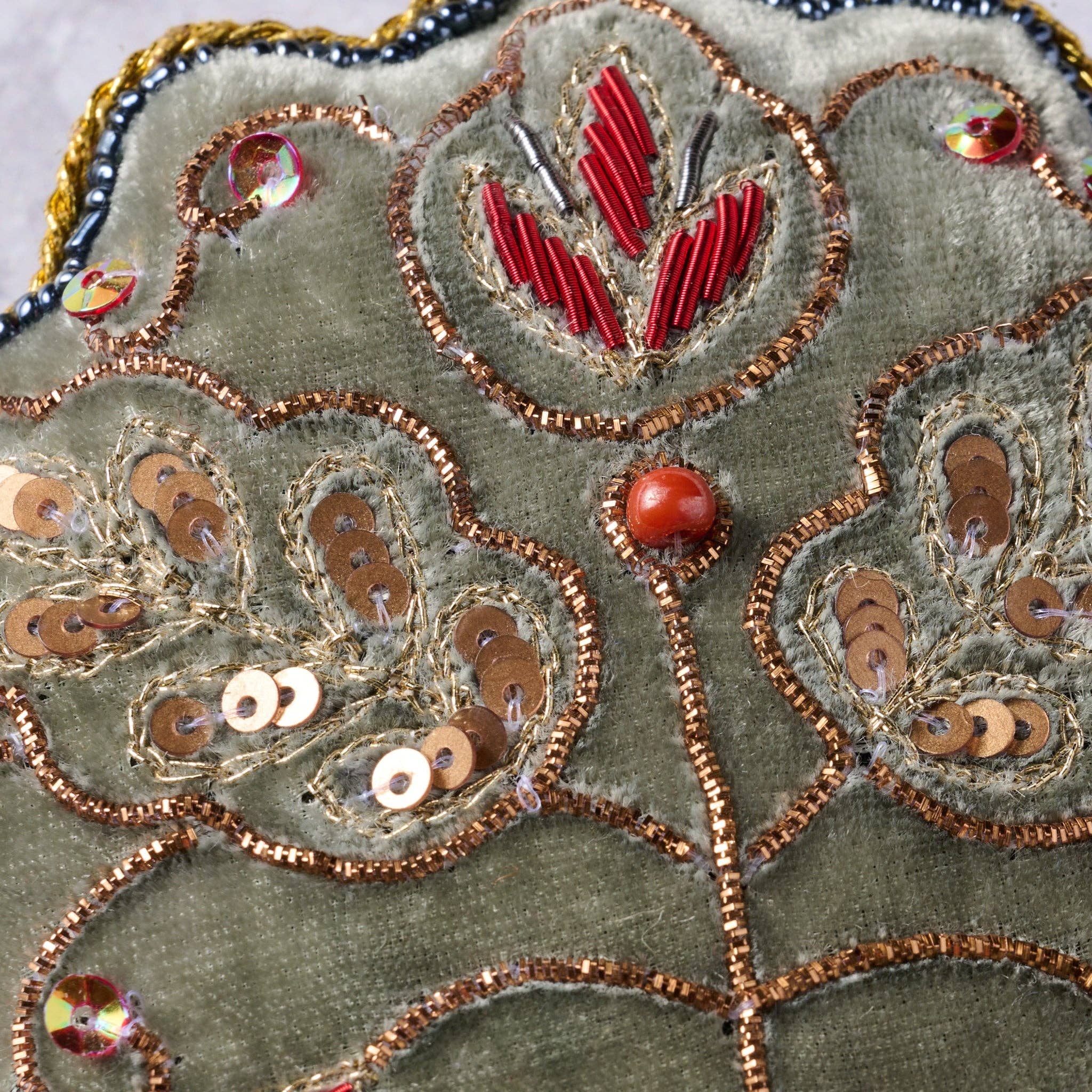 Close up view of the handcrafted sewing and beaded details on the ornament