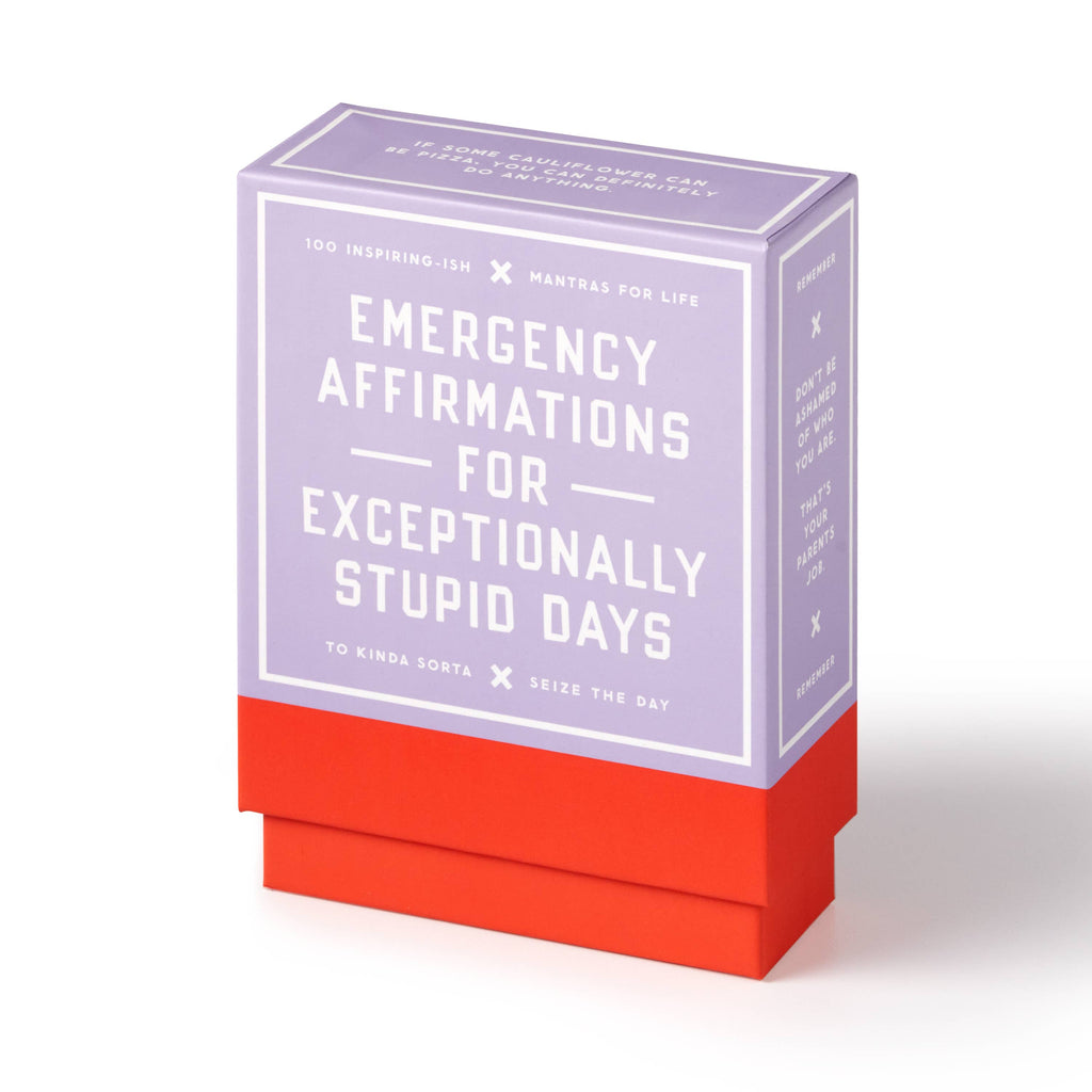 Brass Monkey Emergency Affirmations box with bold retro typography on a styled desk