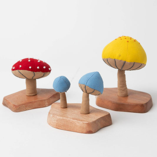 A trio of handcrafted fiber mushroom plants