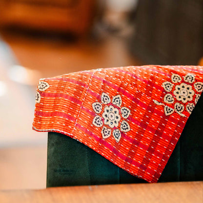 Close-up of a red embroidered fabric with a blurred background