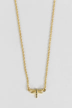 Minimalist dragonfly necklace styled as a meaningful everyday accessory