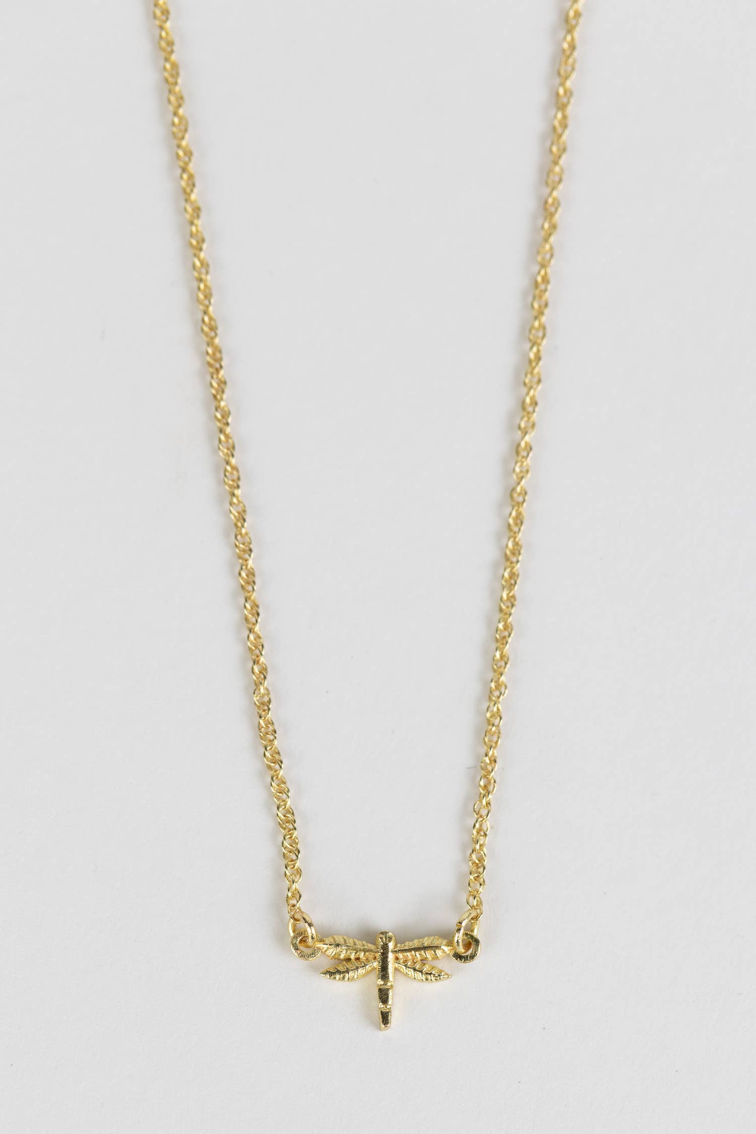Minimalist dragonfly necklace styled as a meaningful everyday accessory