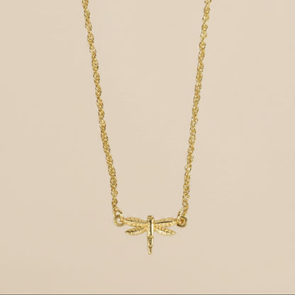 Minimalist dragonfly necklace styled as a meaningful everyday accessory