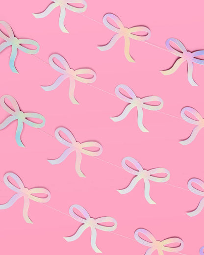 Glam pink bow garland with iridescent foil finish—4 strands, 12' each—perfect for adding sparkle to bridal showers, bachelorette parties, and baby showers.