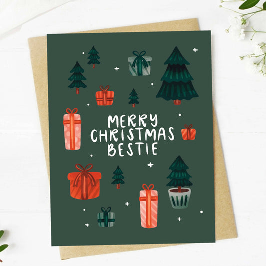 Christmas card with trees, presents, and 'Merry Christmas Bestie' text on a green background.