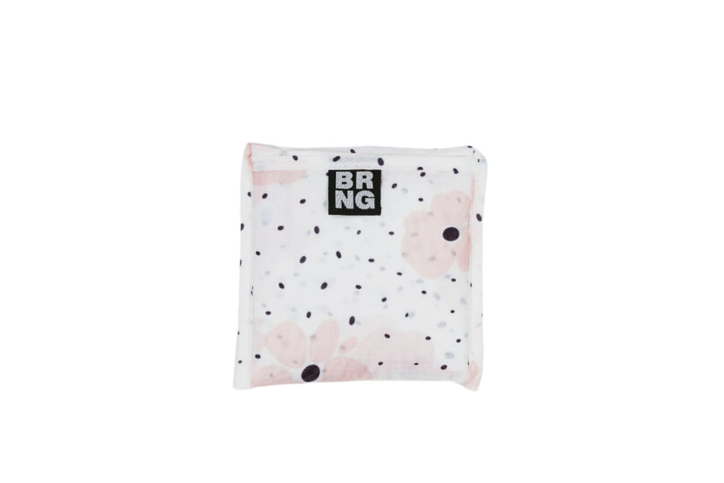 Carley Daily Shopper with pink flowers and black polka dots folded up into a compact size on a white background.