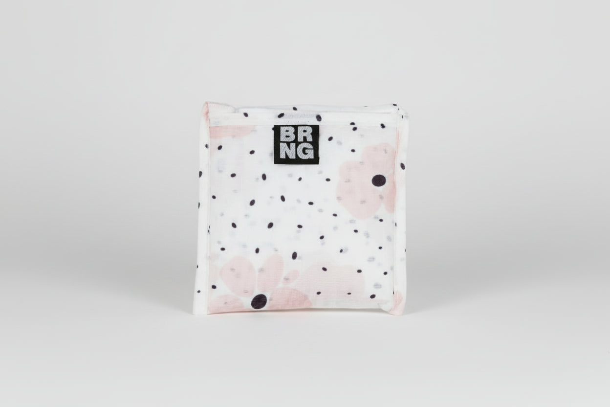 Carley Daily Shopper with pink flowers and black polka dots folded up into a compact size on a white background.
