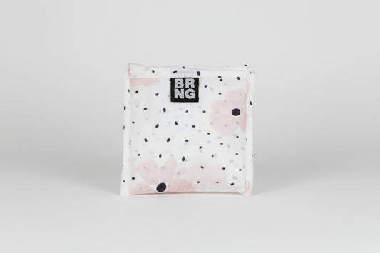 Carley Daily Shopper with pink flowers and black polka dots folded up into a compact size on a white background.