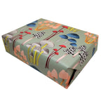 A gift wrapped in the Mushroom on Soft Green Gift Wrap Sheets from Rochambeau Home