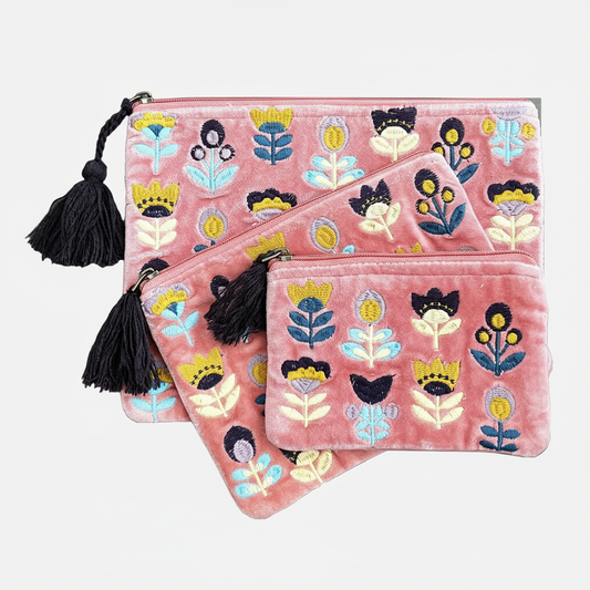 Three pink pouches with tulips embroidered in multicolor thread on a white background
