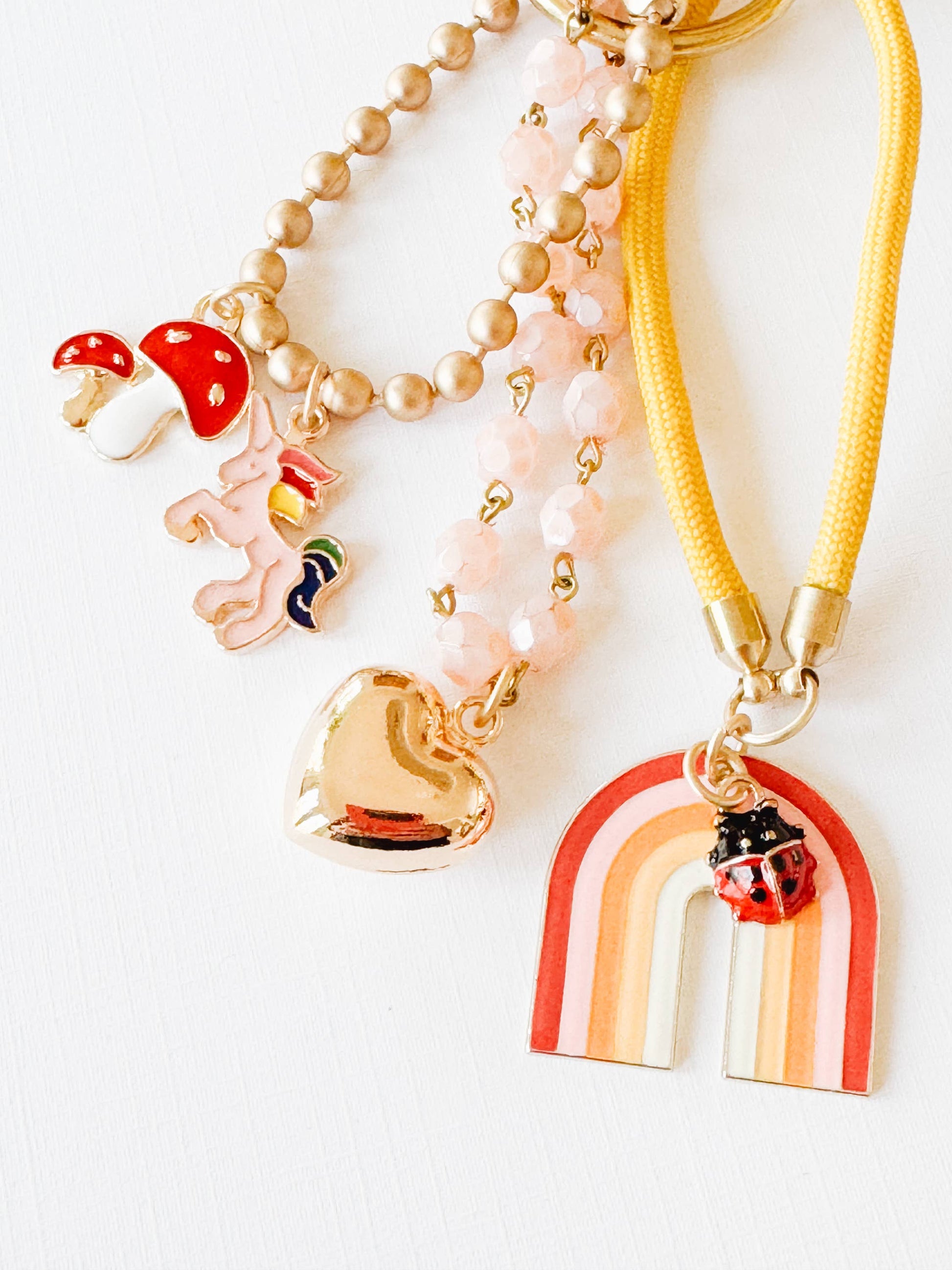 Close-up of the pink bead chain and gold puffy heart