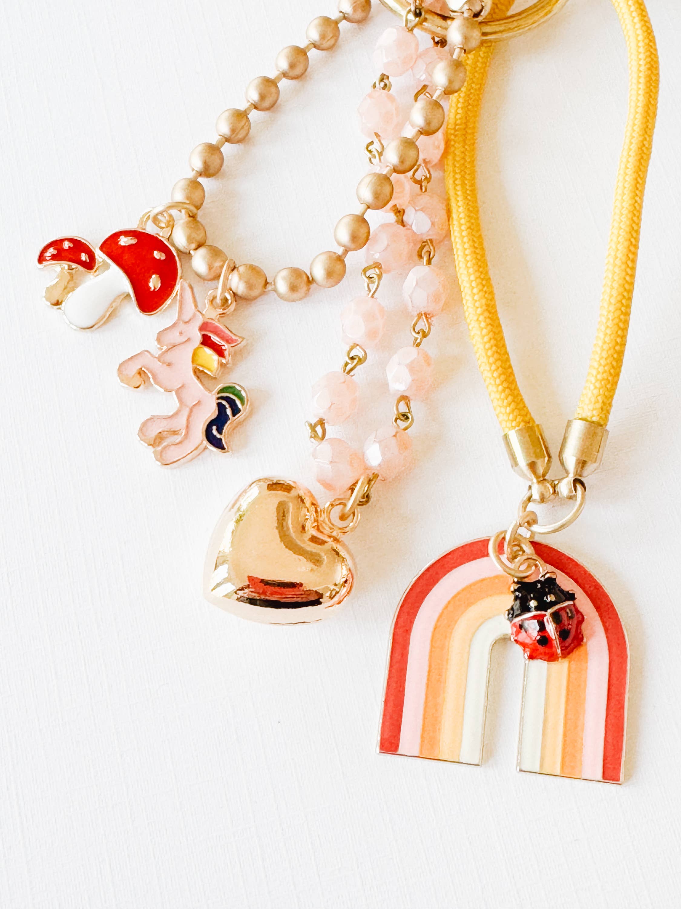 Close-up of the pink bead chain and gold puffy heart