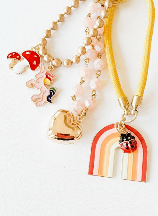 Close-up of the pink bead chain and gold puffy heart