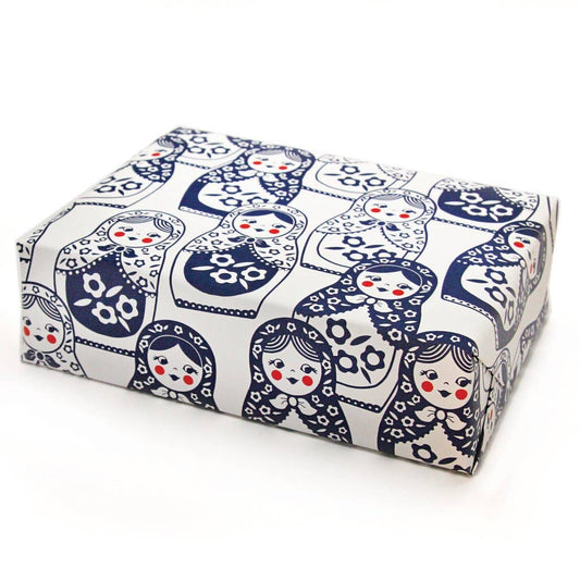 A gift wrapped in the Matryoshka Doll Holiday Gift Wrap with a white background