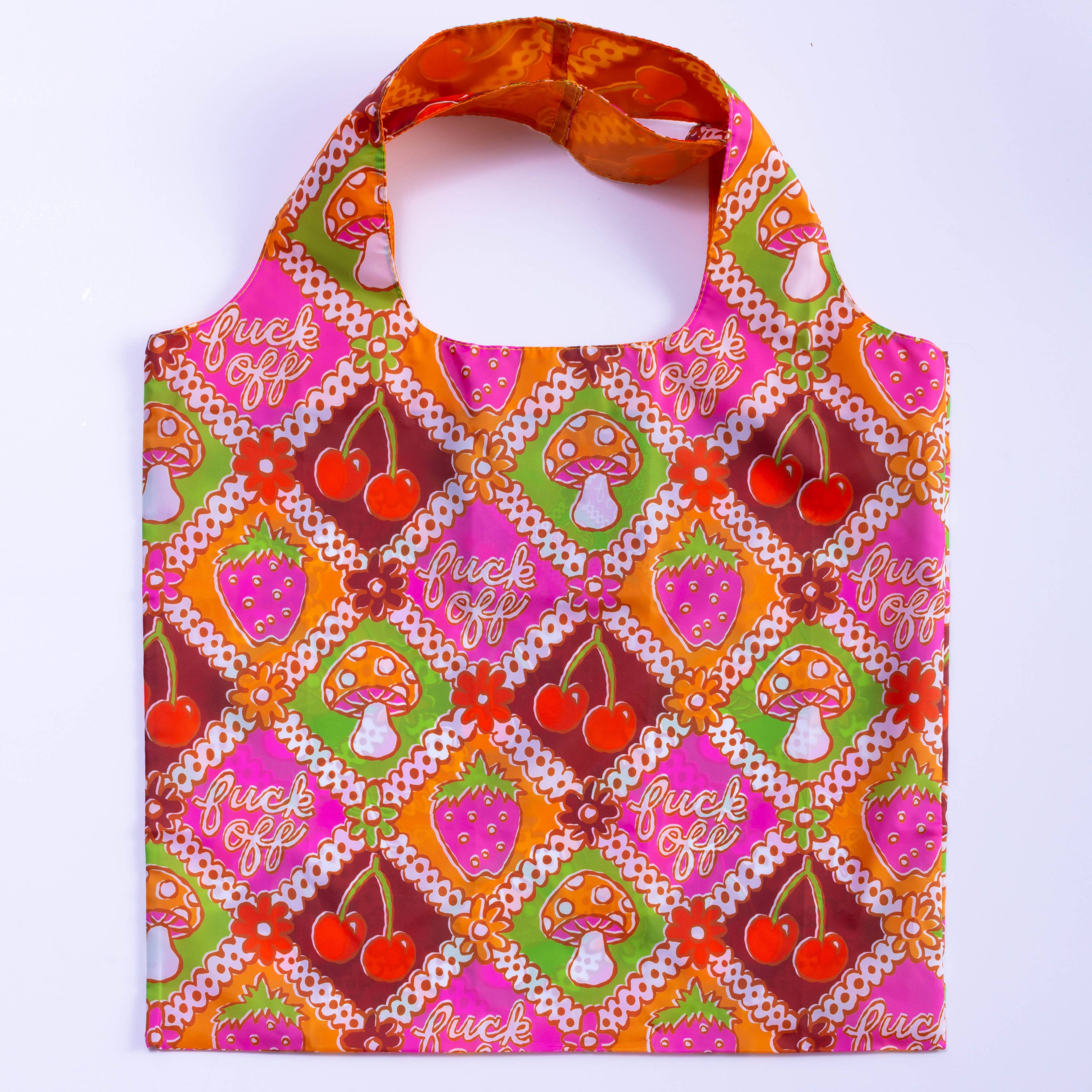 A colorful tote bag with a pattern of cherries, strawberries, and mushrooms in a retro style.