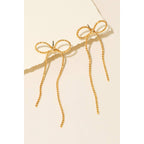 Gold rope chain and ribbon bow dangle stud earrings displayed on card