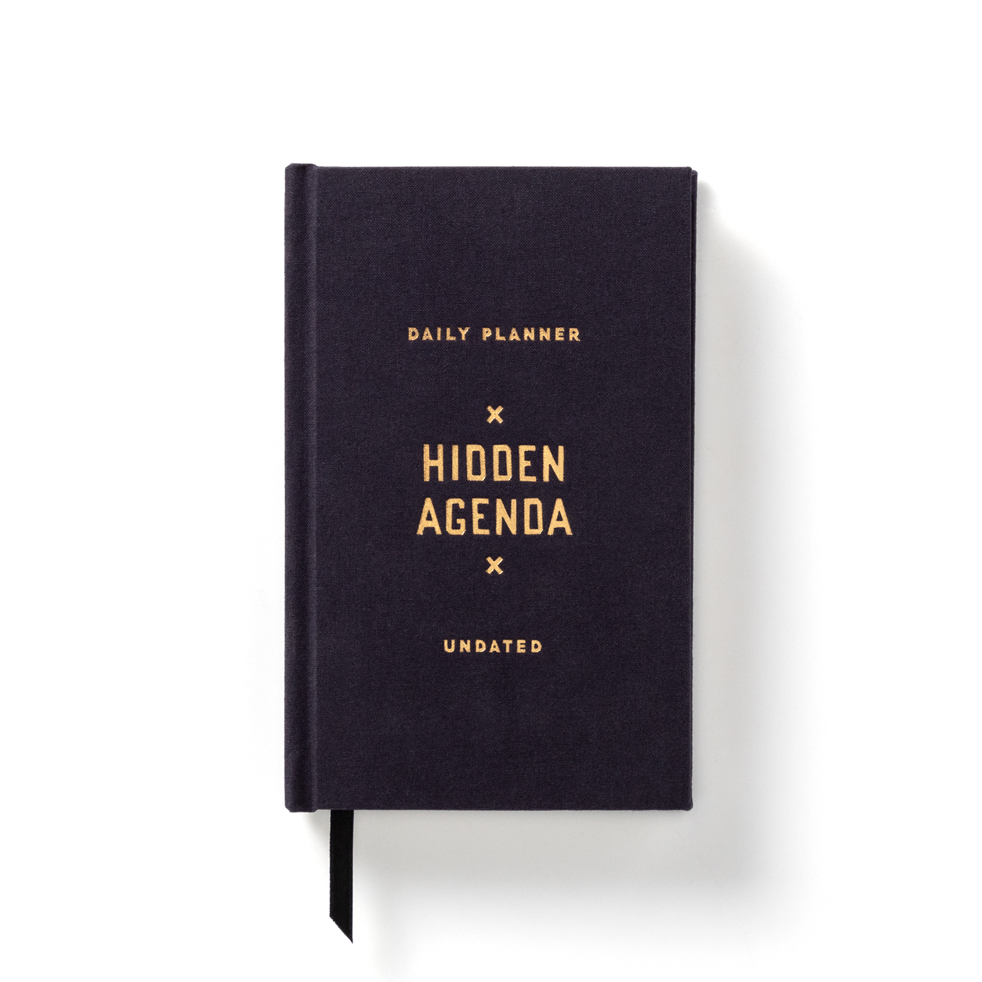 Cloth-bound Hidden Agenda planner with embossed cover design