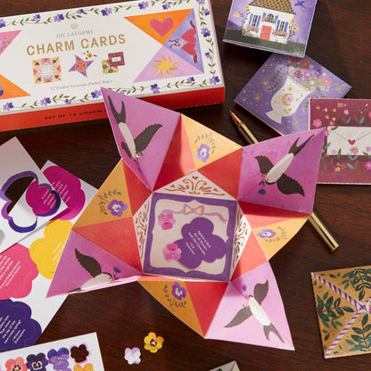 Colorful charm cards with various designs on a wooden surface