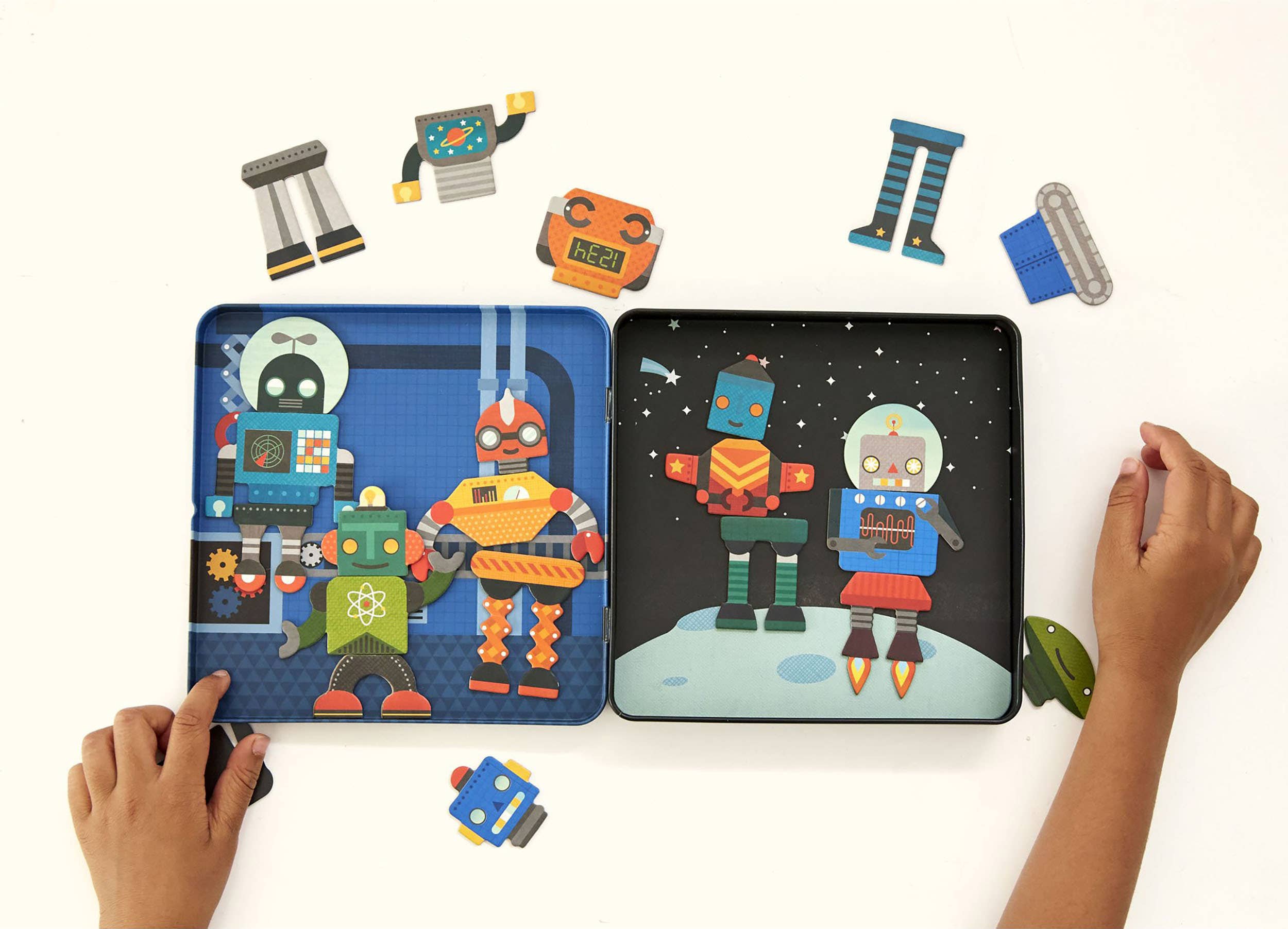 Child’s hands assembling robot pieces inside open tin