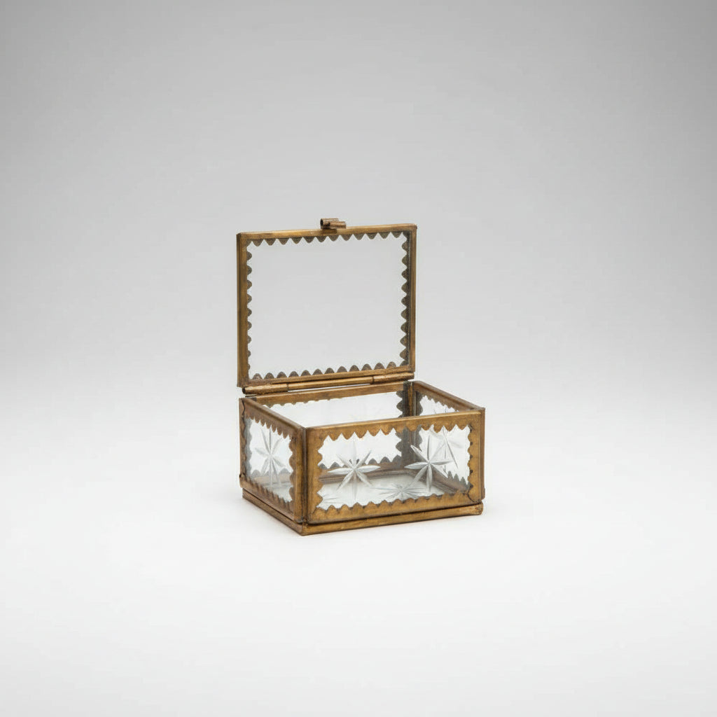 Image of the glass box open showing the details of the brass and etched glass with stars