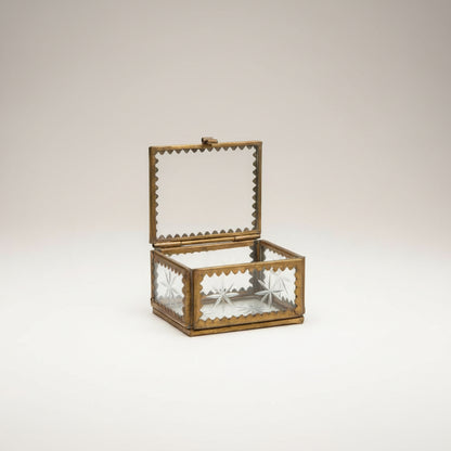 Image of the glass box open showing the details of the brass and etched glass with stars