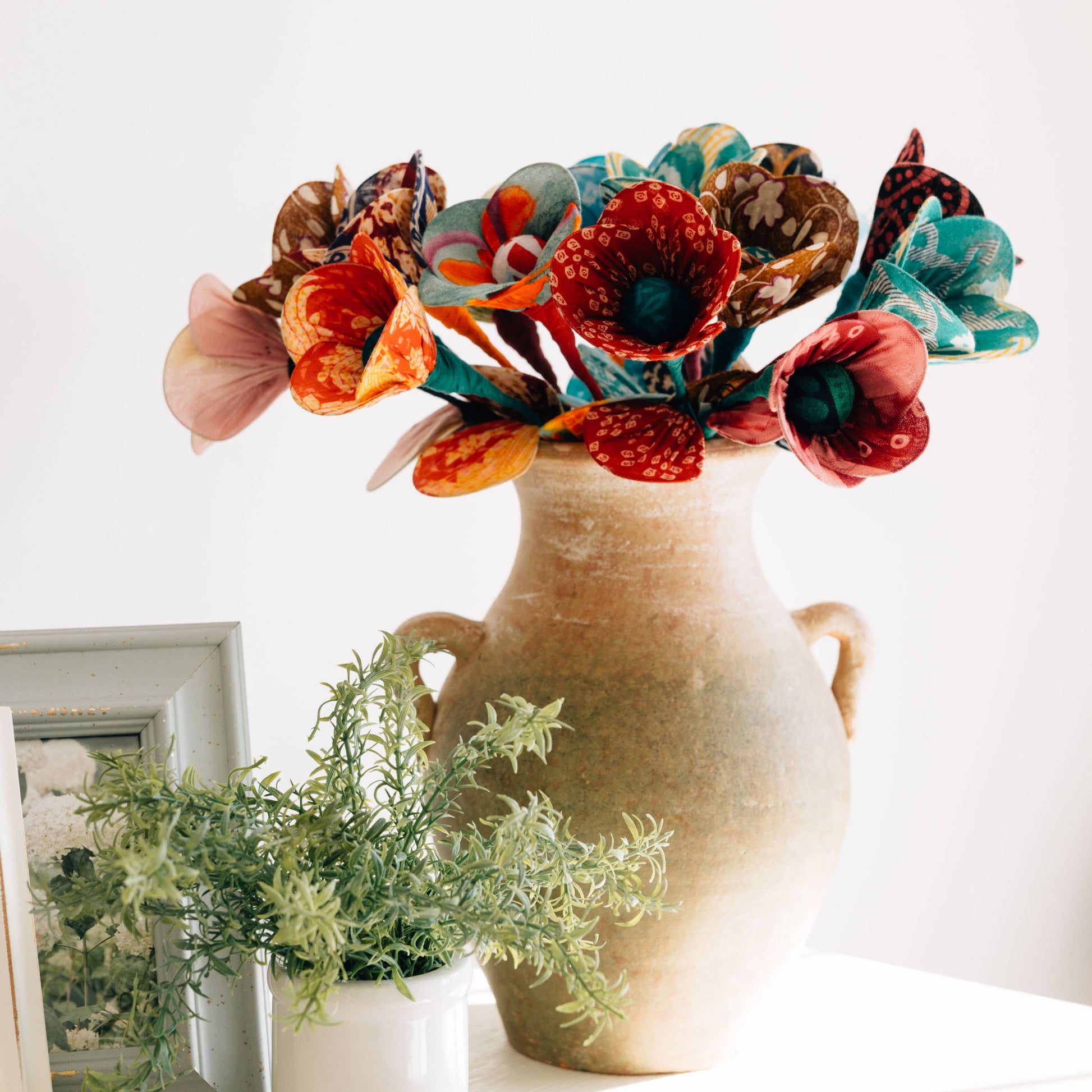 Recycled sari flower styled in a vase with other fabric stems