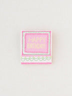 Close up of the matchbook closed, showing the front that says, "Happy Birthday".