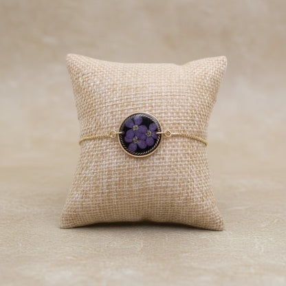 Bracelet with floral design on a textured beige surface