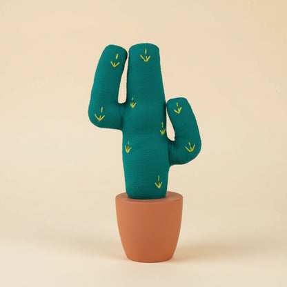 Miniature cotton saguaro cactus with clay-toned base on desk