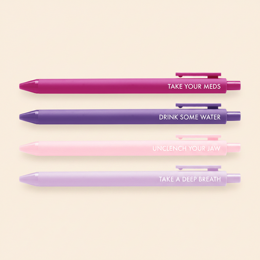 Four pens in different colors with self care motivational phrases on a white background