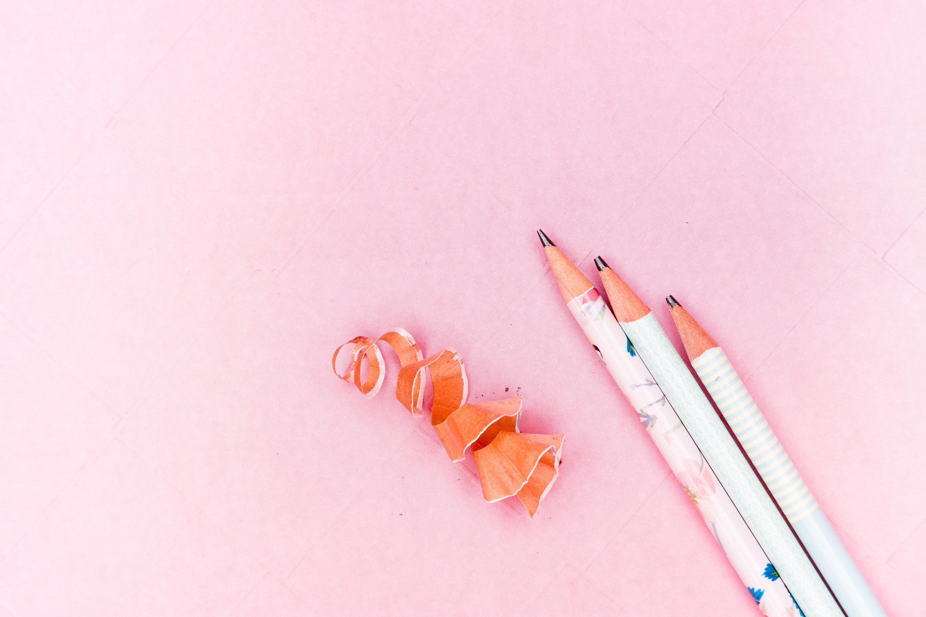 Image of sharpened pencils with a pink backdrop