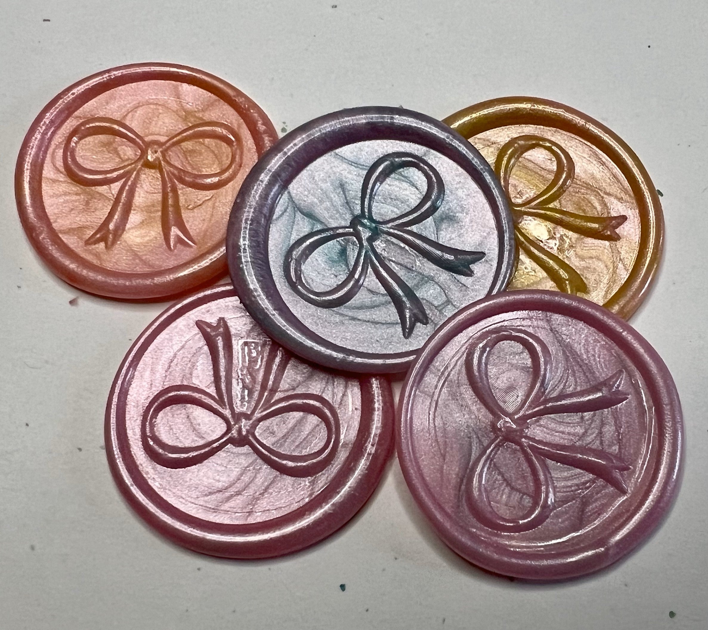 Elegant pink bow wax seal tags for gift wrapping, offering sophistication and charm for every occasion.